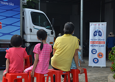At a community TB testing event in Tien Giang province, Viet Nam, people wait to be tested in a mobile x-ray van. Photo credit: FHI 360 staff 